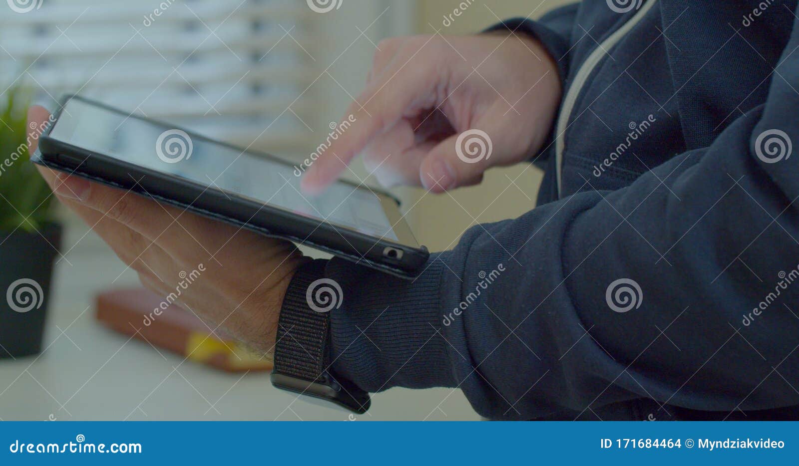 close-up shot of male hands in profile typing in messenger using tabletpc. hands typing text on tabletpc close-up.