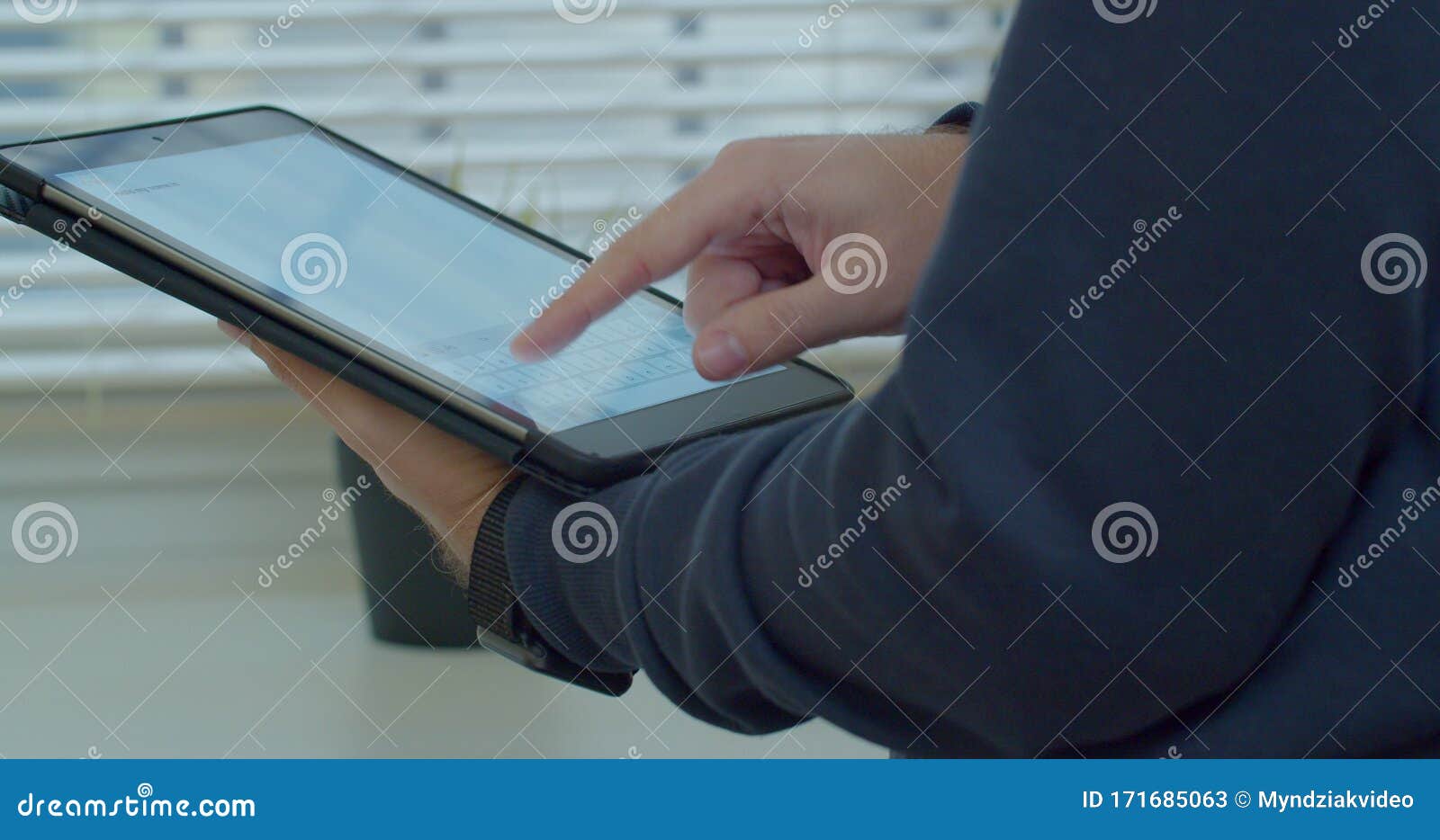 close-up shot of male hands in profile typing in messenger using tabletpc. hands typing text on tabletpc close-up.