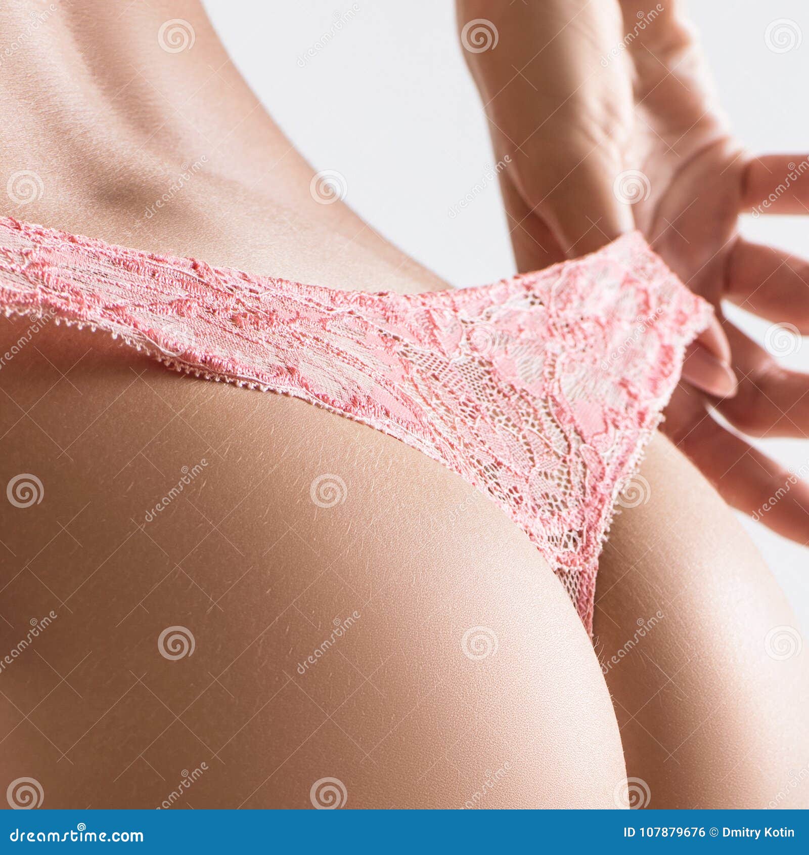 Sexy beautiful woman taking off her lace panties. - Stock Photo