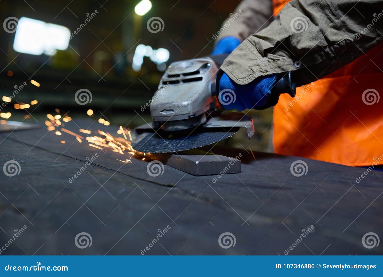 steel plant worker using angle grinder