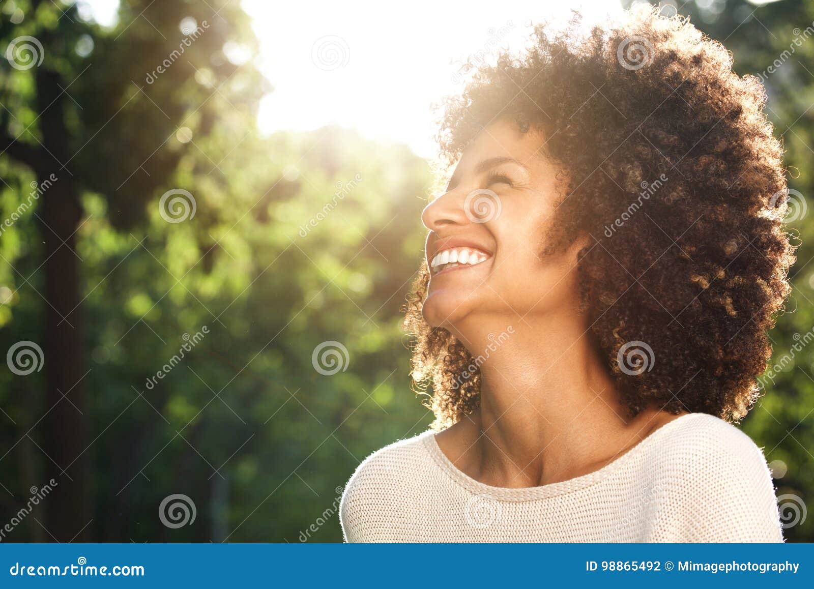 close up portrait of beautiful confident woman laughing in nature