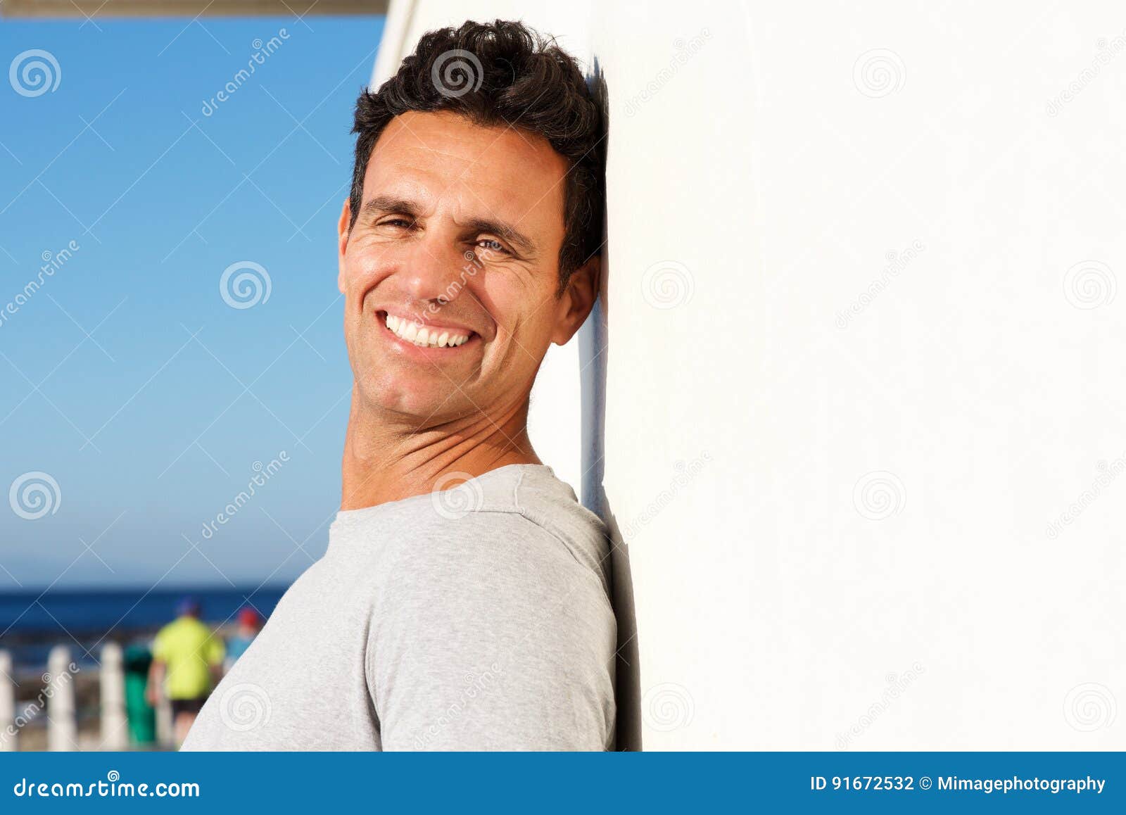 Close Up Side Portrait of Happy Older Guy Leaning Against Wall Stock ...