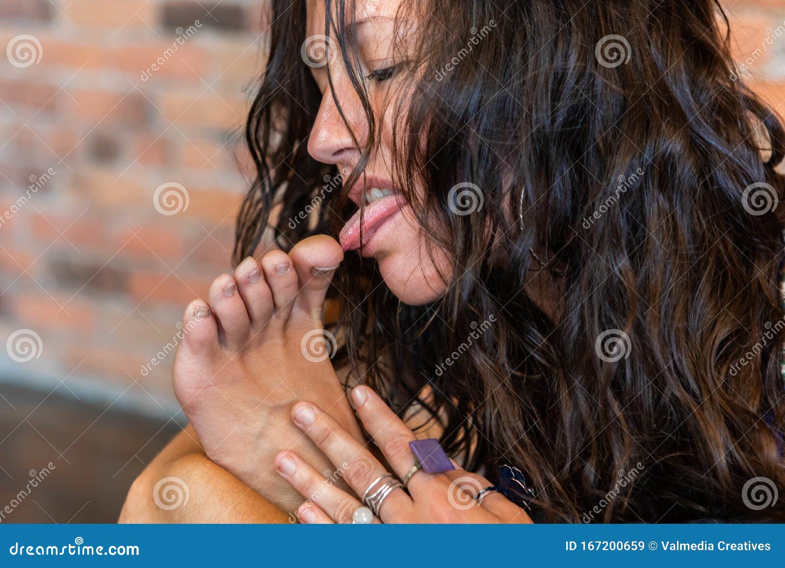 woman licking man's feet