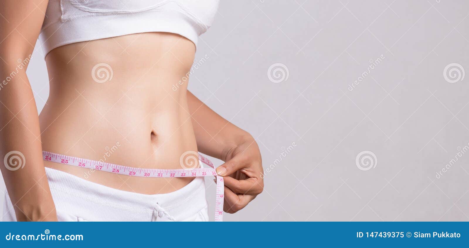 Close Up Slim Young Woman Measuring Her Thin Waist with a Tape Measure.  Healthcare and Woman Diet Lifestyle Concept To Reduce Stock Image - Image  of muscle, attractive: 147439375