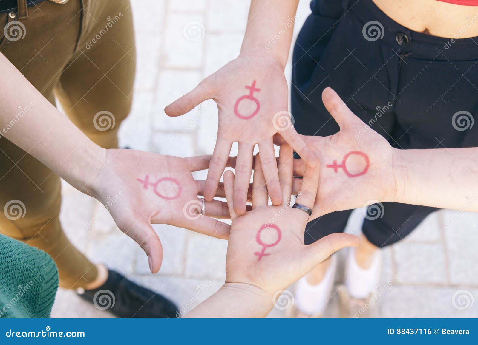 close up of small group of women with the  of feminism written on her hands