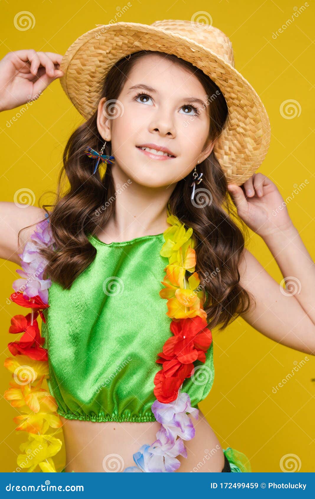 Happy Small Girl Holding Hat with Hands and Looking Up in Studio Stock ...