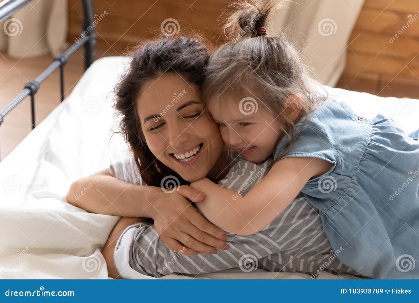 Close Up Smiling Mother And Little Daughter Cuddling In Bed Stock Image Image Of Indoor Lying 