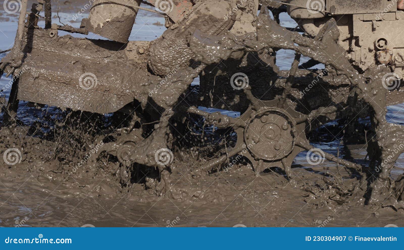 a close up of splashes of mud on a grouser of a tilling machine. a plougher equipment on a farm. taming soil before