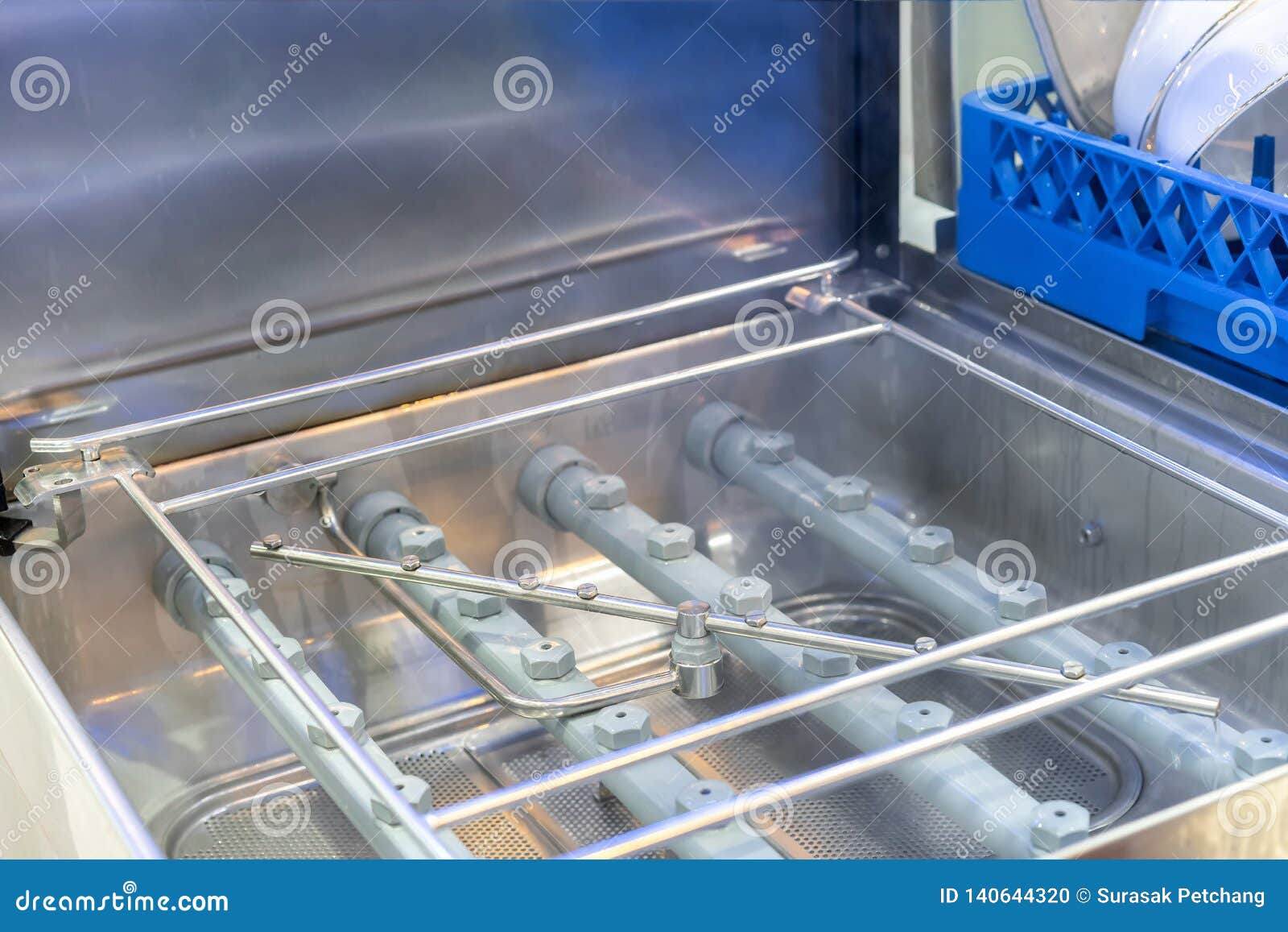 Close Up Spraying Nozzle and Detail Inside of Automatic Dishwasher