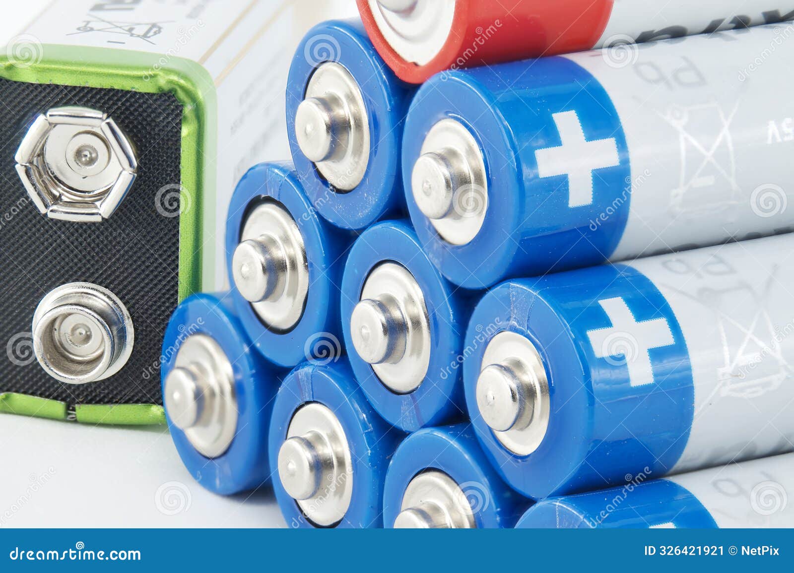 close-up of stacked aa batteries showing the positive terminals