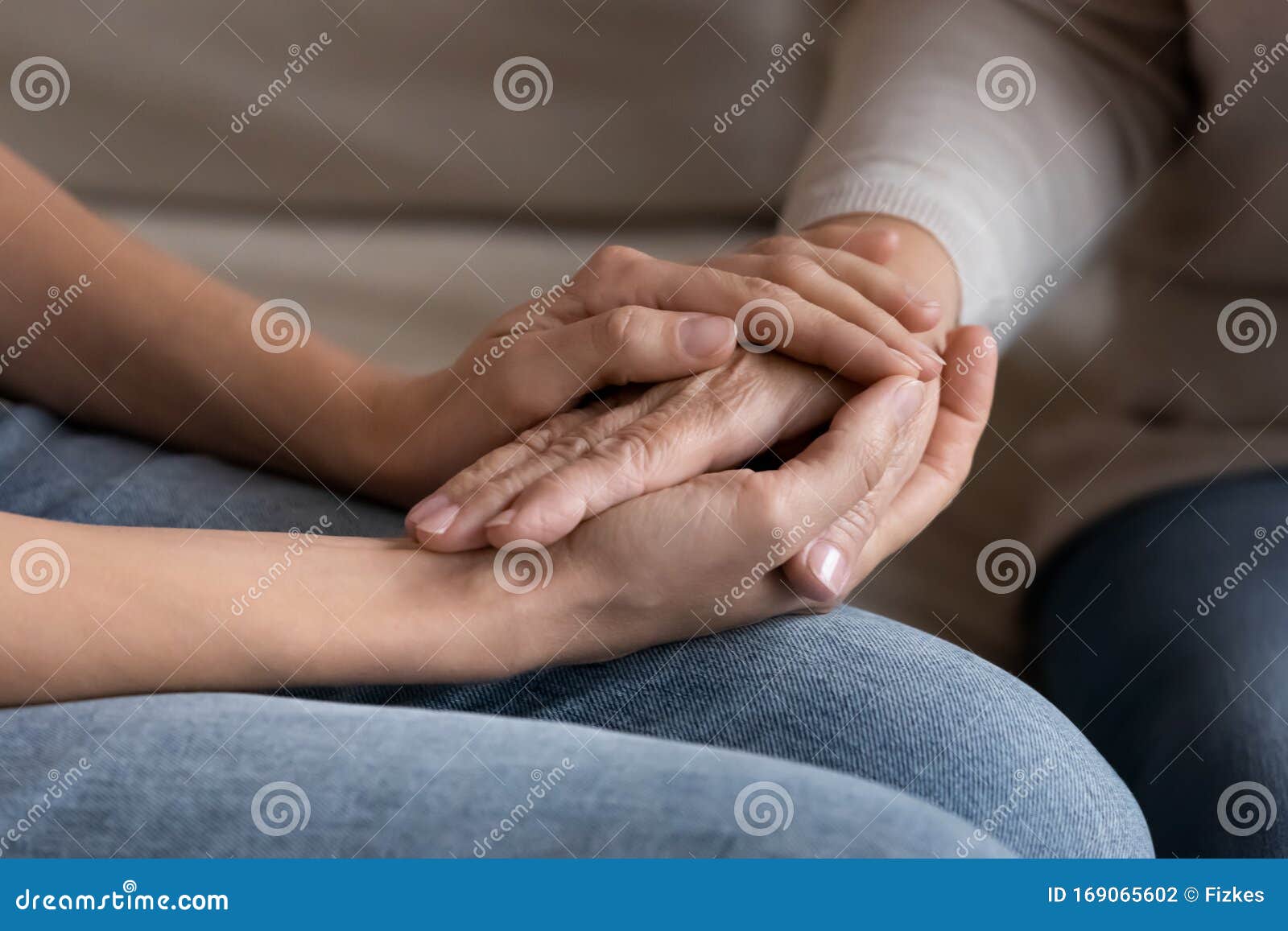 supportive adult daughter hold senior mom hands