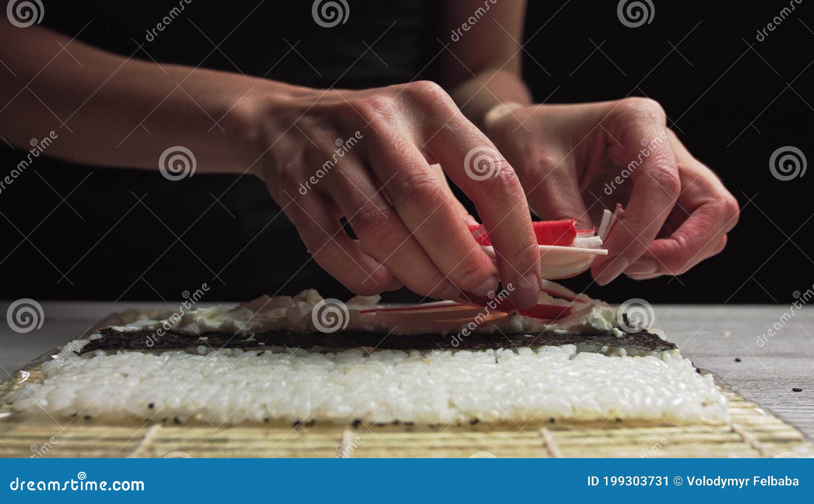 Closeup of Sushi Chef Hands Puts Crabs on a Nori Leaf and Crab Meat.Sushi Making Process Stock