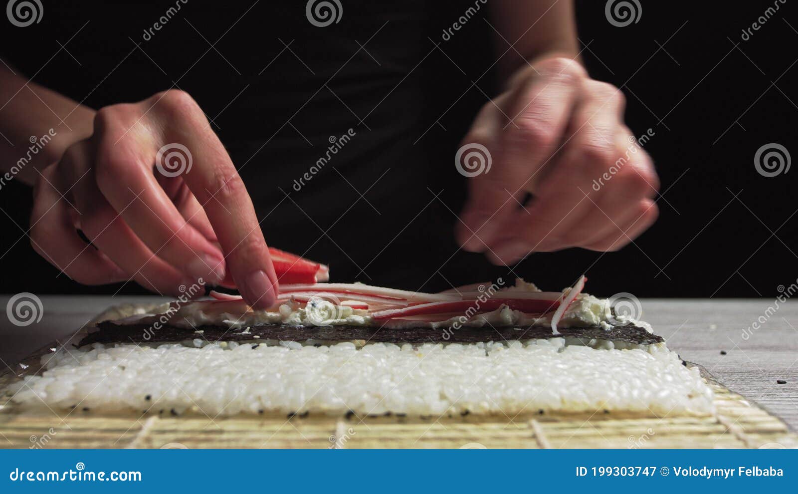 Closeup of Sushi Chef Hands Puts Crabs on a Nori Leaf and Crab Meat.Sushi Making Process Stock