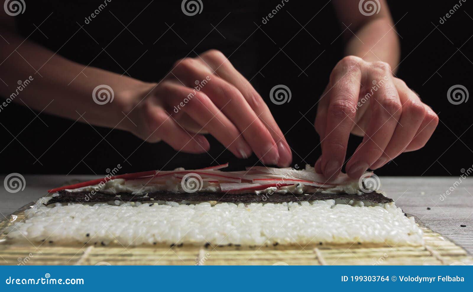 Closeup of Sushi Chef Hands Puts Crabs on a Nori Leaf and Crab Meat.Sushi Making Process Stock