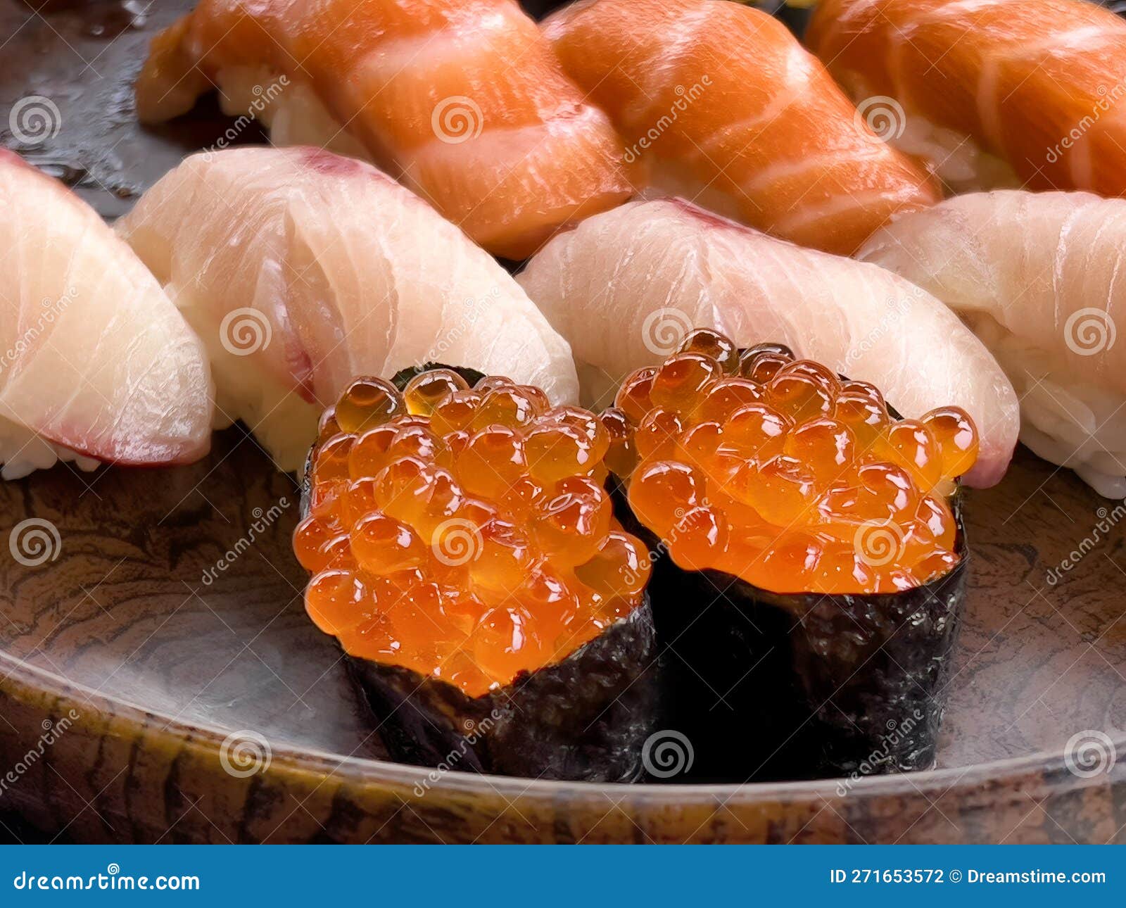 Close Up of Sushi Salmon Fish Eggs with Yellow Tail and Salmon Pieces