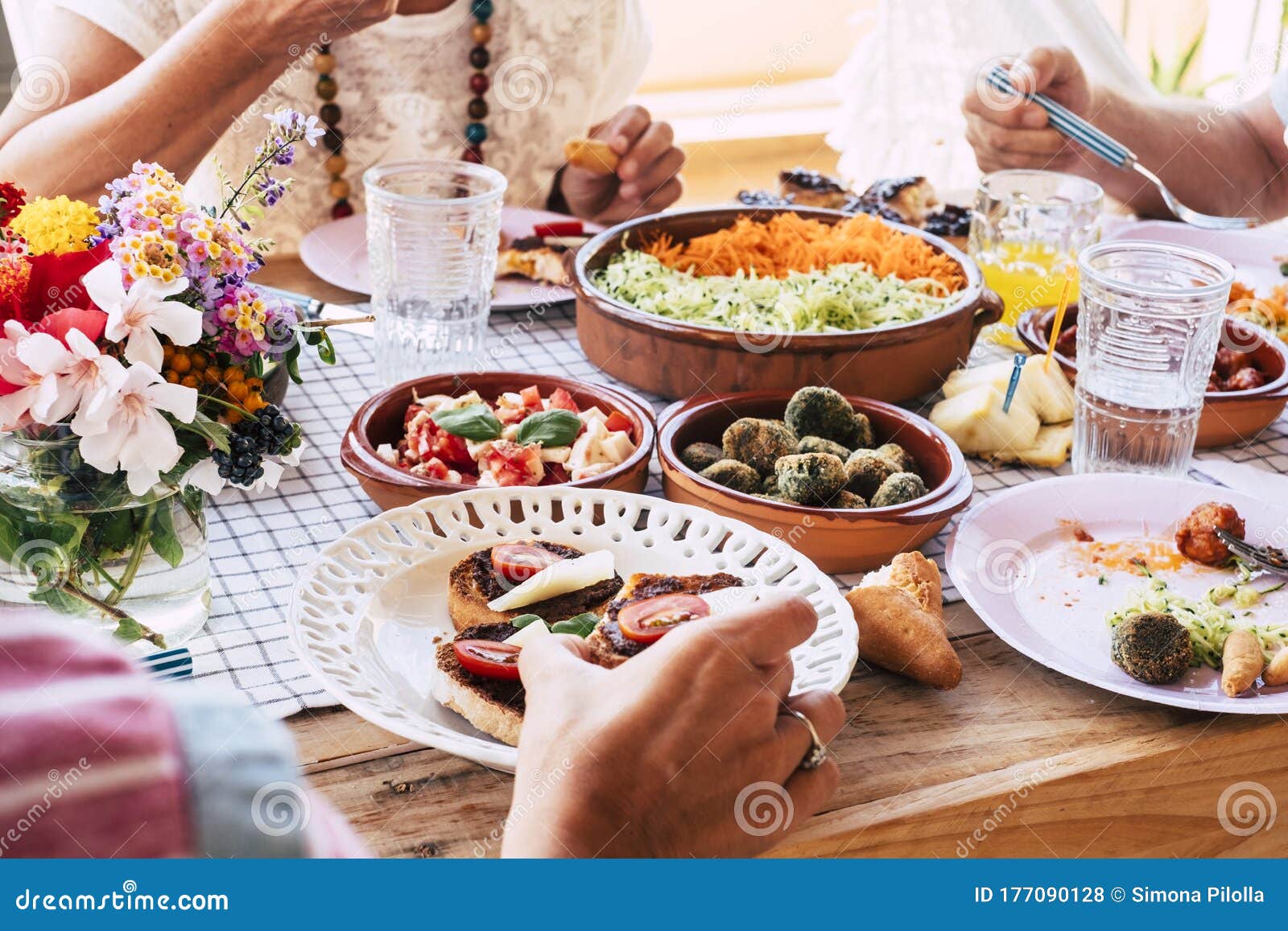 Close Up of Table Full of Fresh Vegetarian Vegan Food with Group of ...