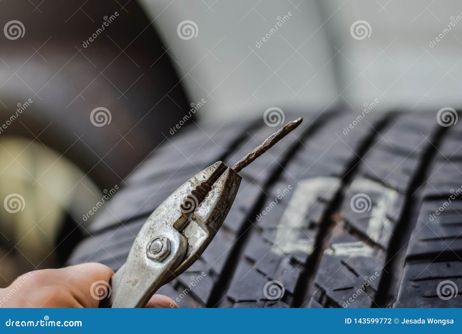 Close Up Tack in Tire ,Flat Tire the Tire is Leaking from the Nail Can