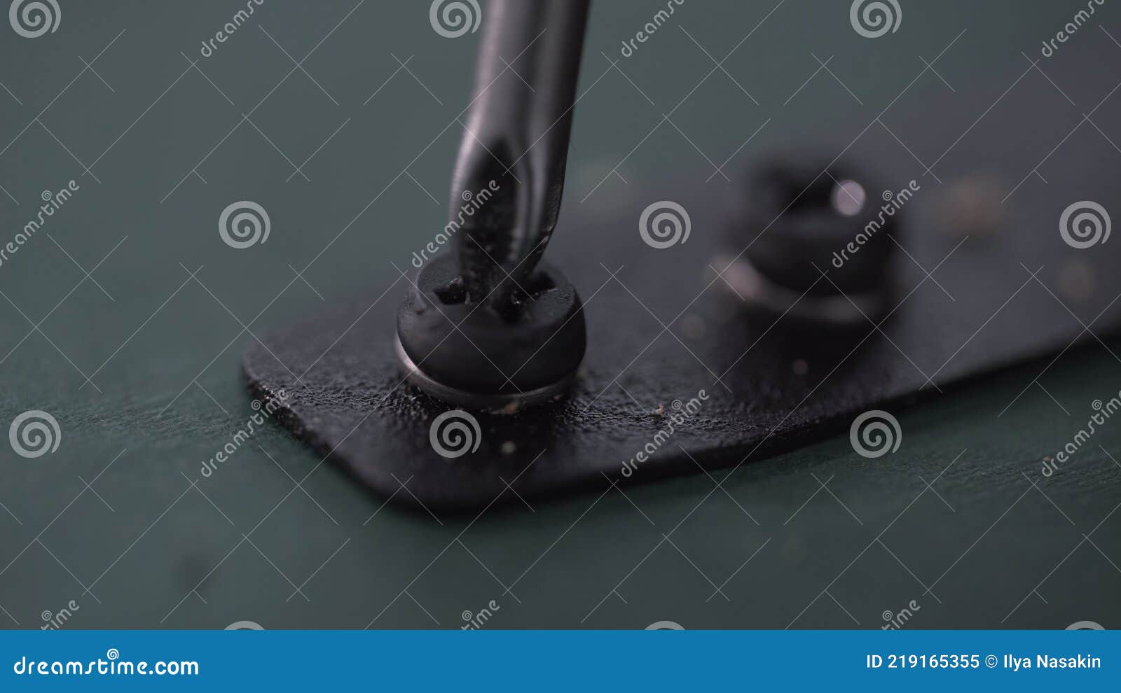 Close Up of Tools Screwdriver Turning a Screw. Cam Lock is Inserted