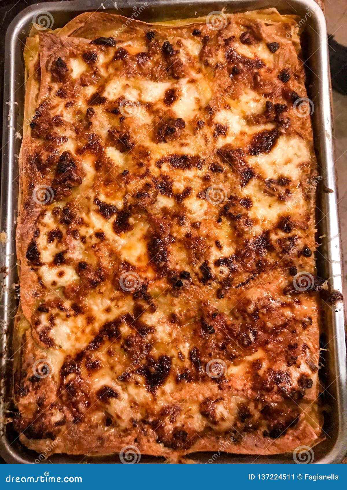 close up and top view of a glorious home made lasagna, freshly baked