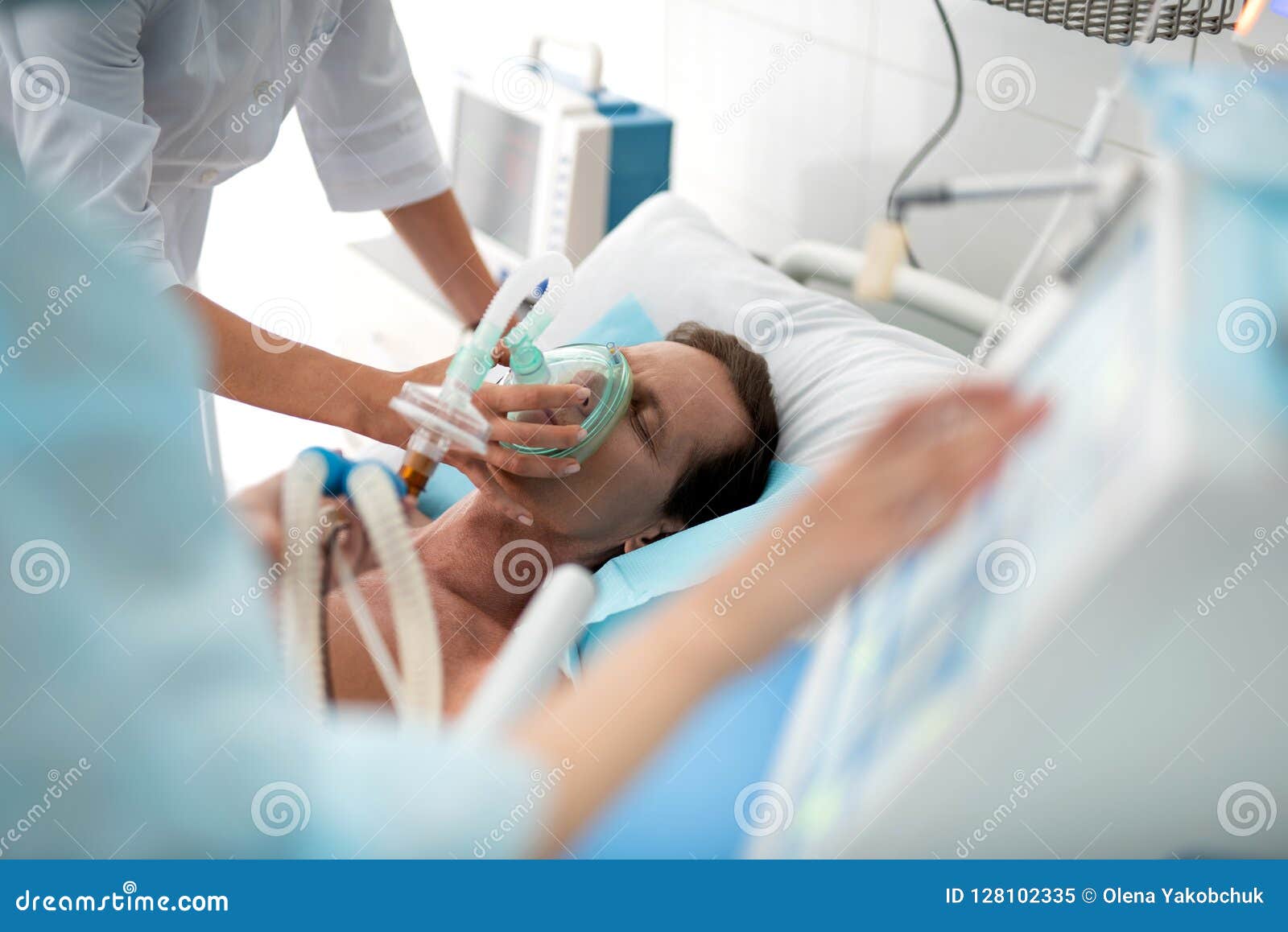 doctor putting oxygen mask on patient in critical state