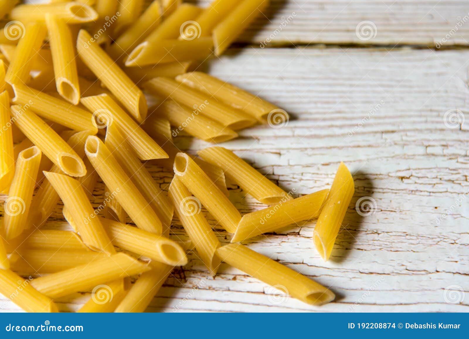 close up of uncooked penne pasta