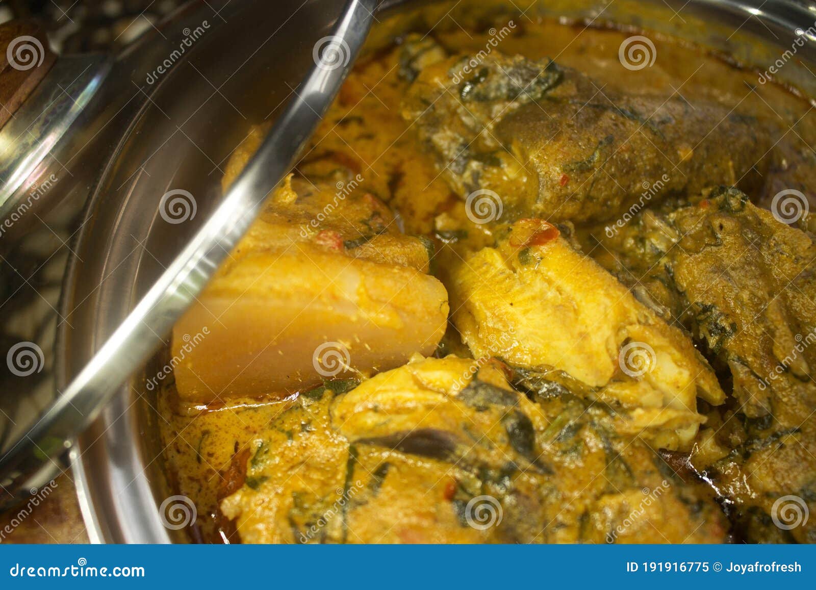 a close up view of assorted meat in a pot of nigerian soup