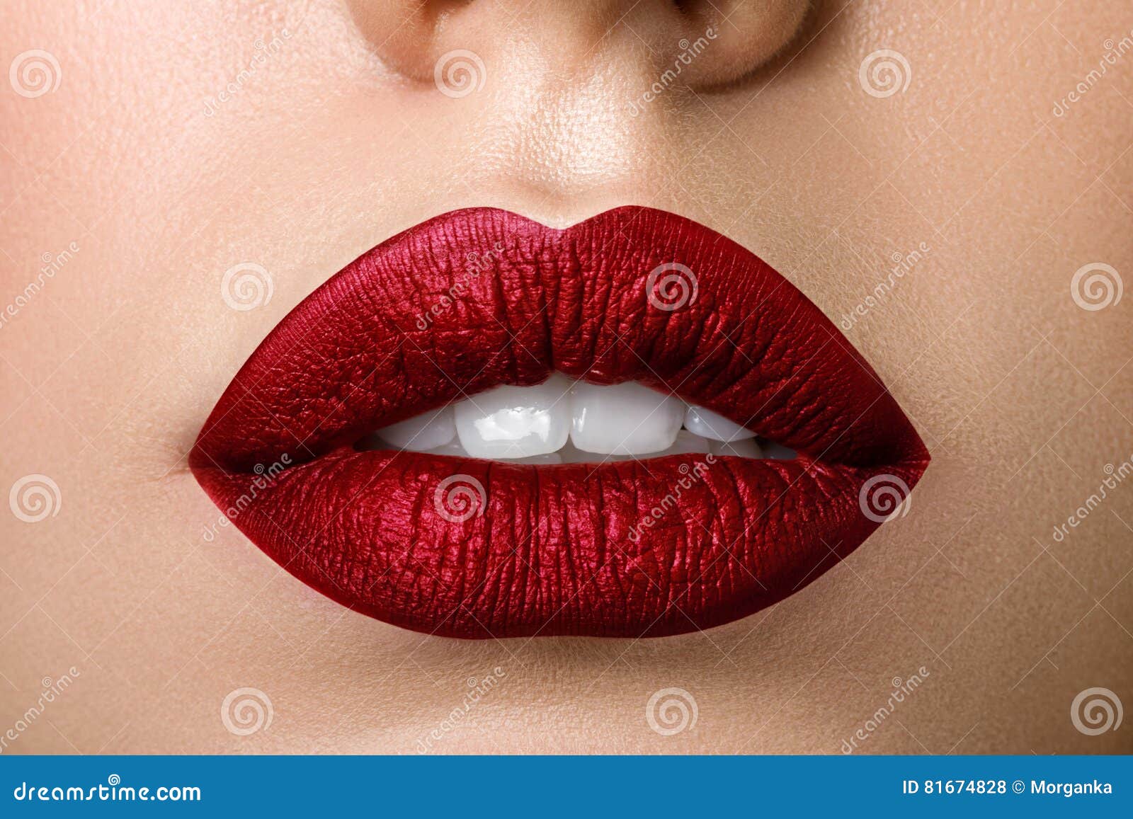 close up view of beautiful woman lips with red matt lipstick