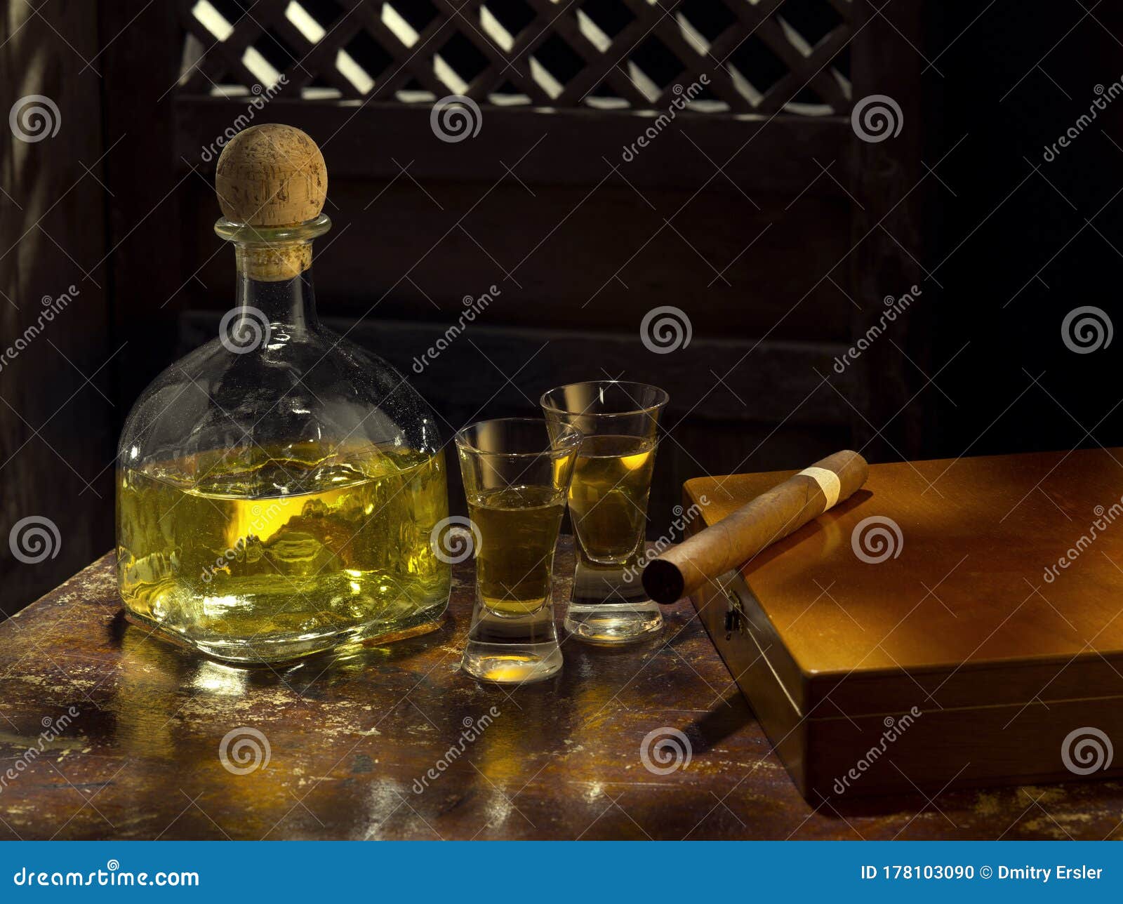 Bottle Of Tequila Anejo And Cigar On Color Background Stock Photo