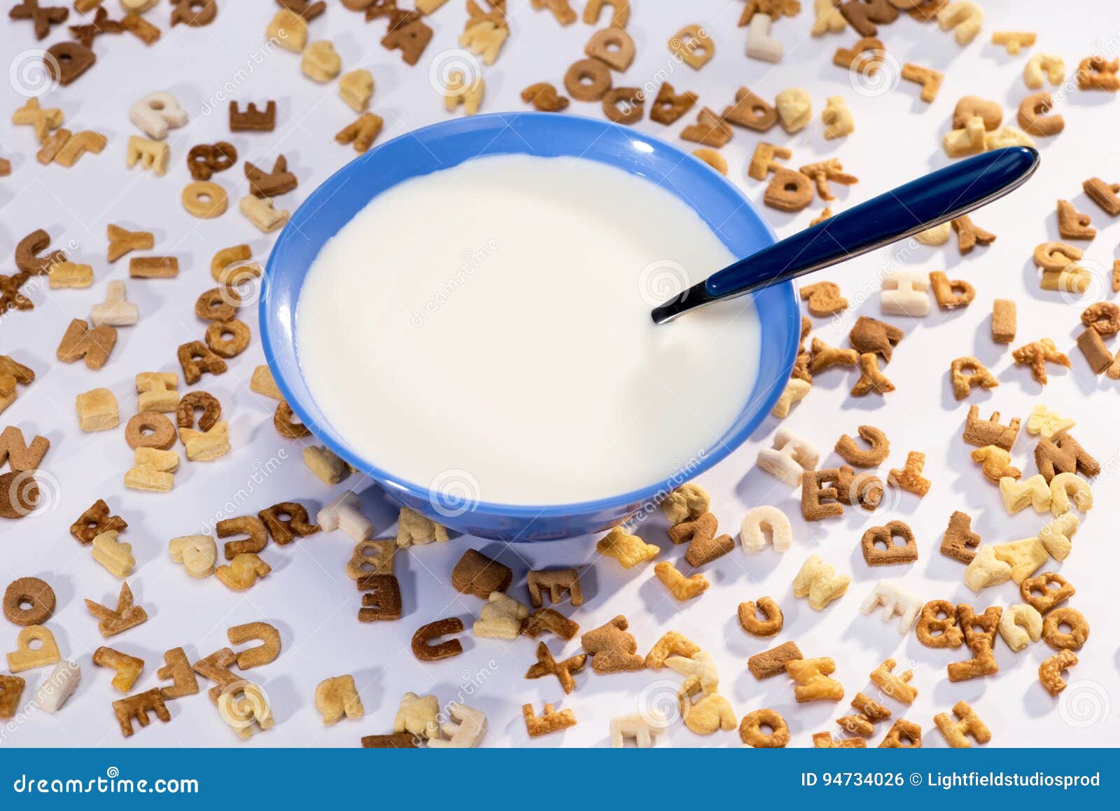 Closeup View of Breakfast Cereal Alphabet, Milk in Bowl and Spoon