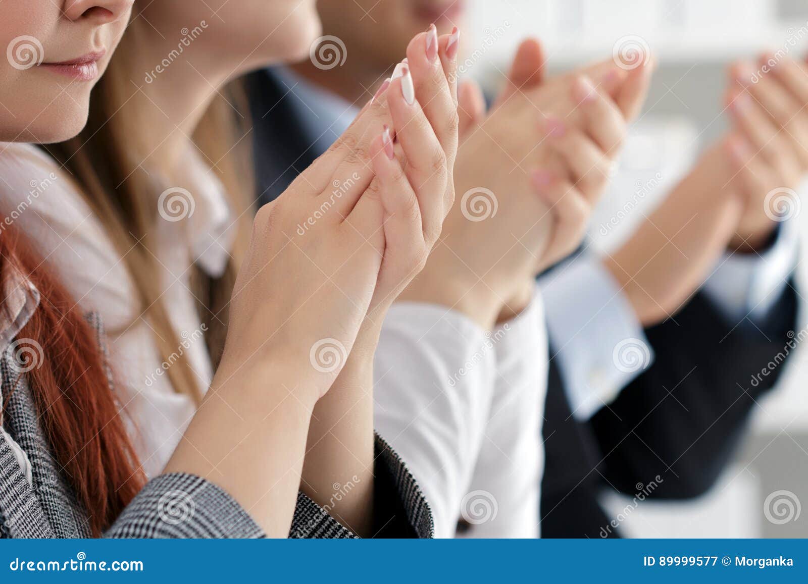close up view of business seminar listeners clapping hands