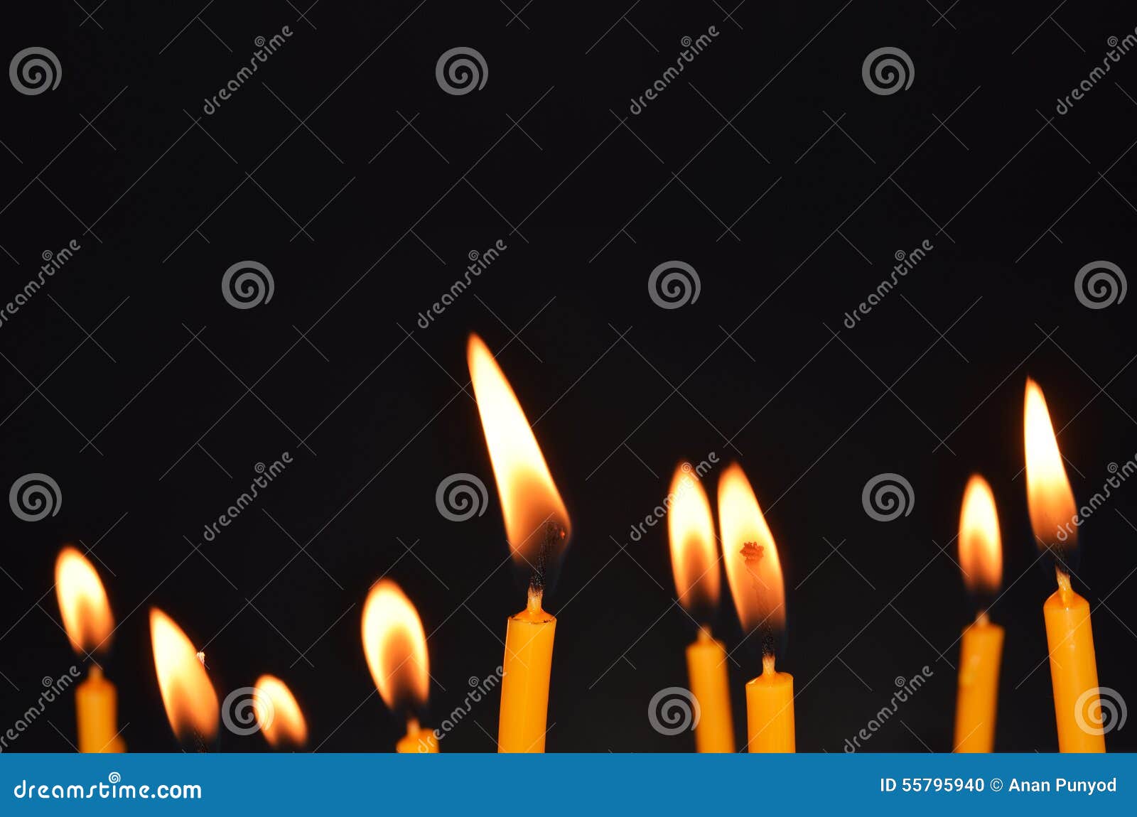 Close Up View of the Candles Burning Brightly in the Dark. Stock Photo