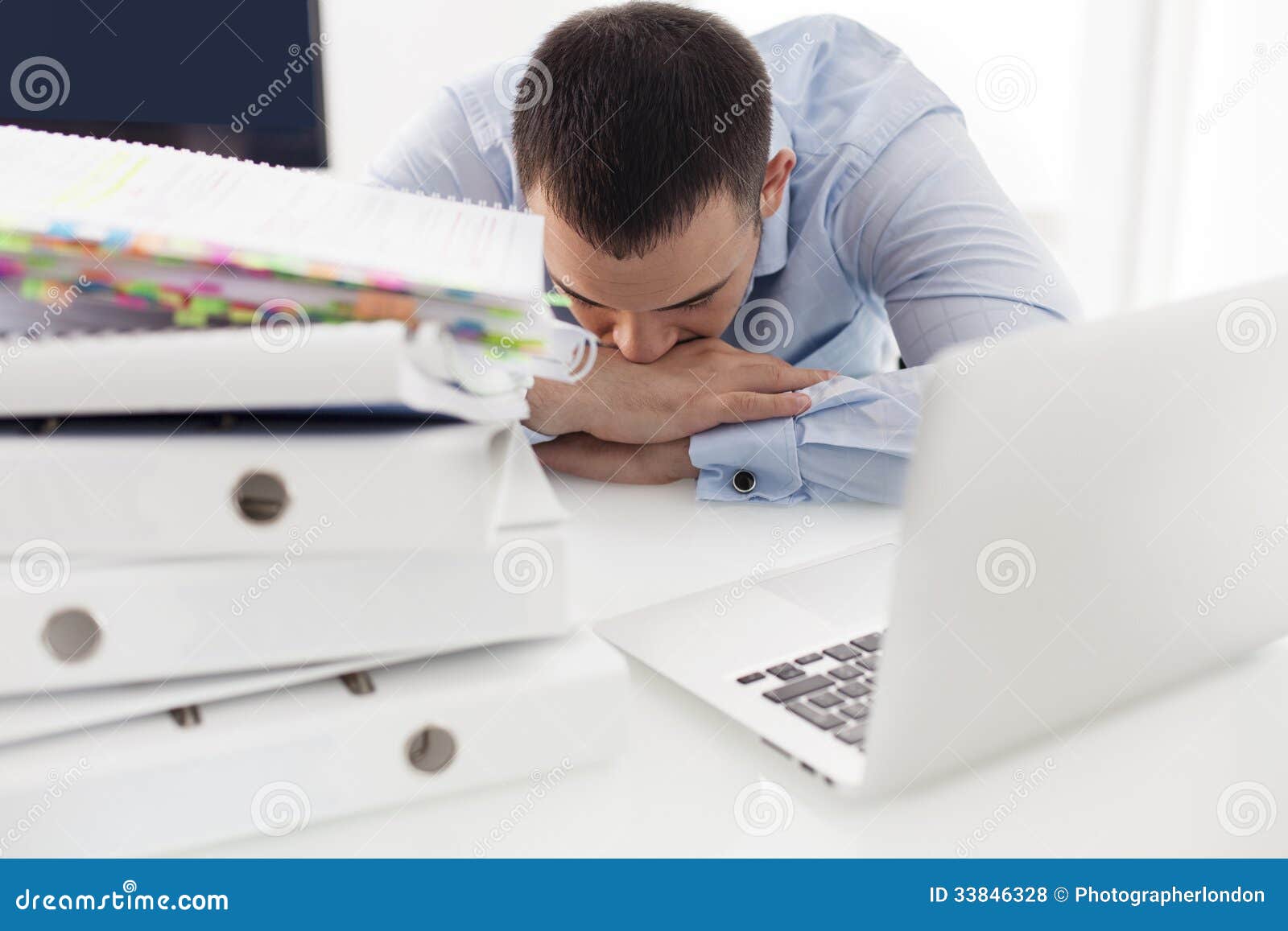 close-up view of caucasian businessman asleep at his desk