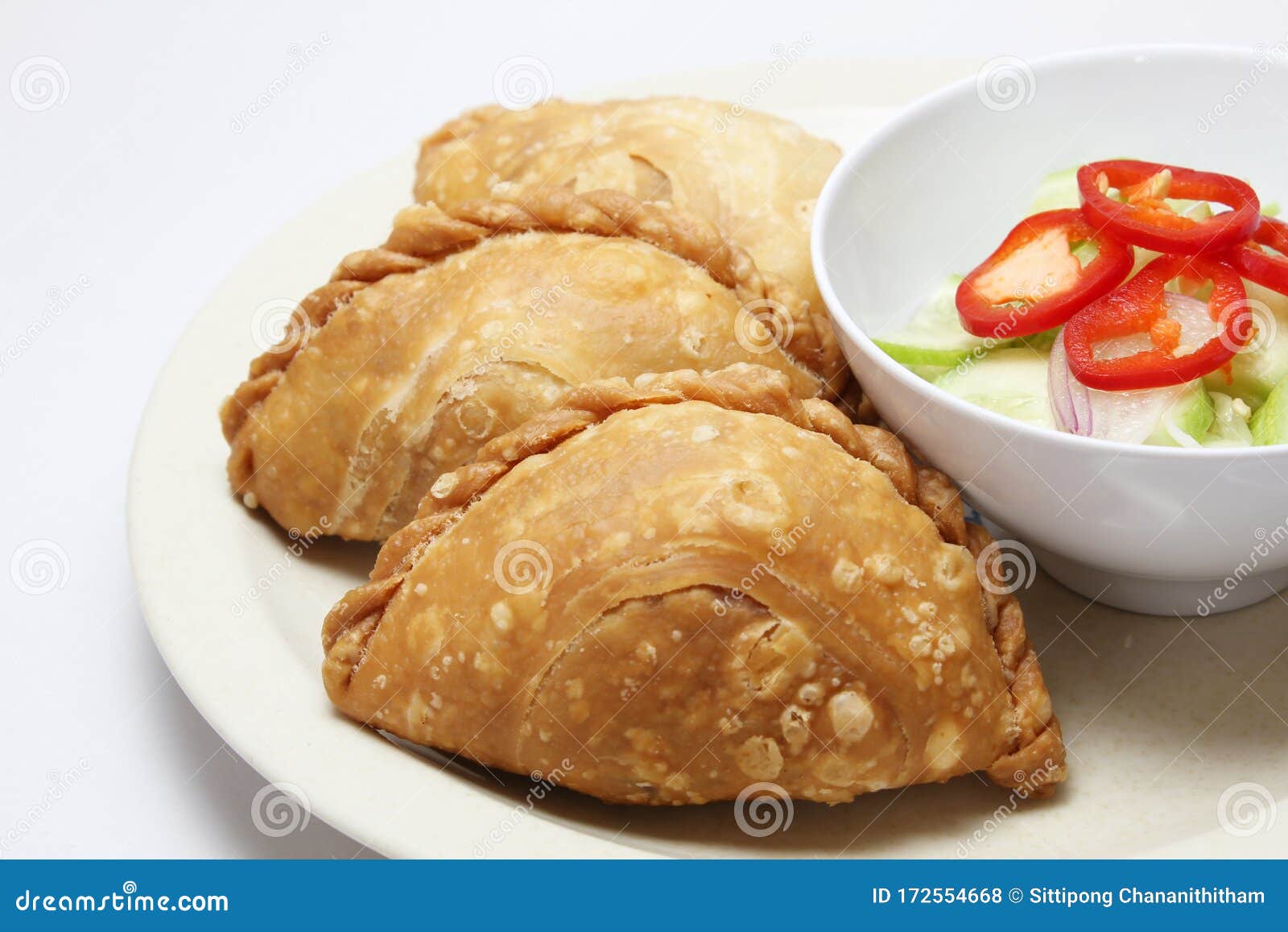curry puff in a dish serve with spicy sour cucumber