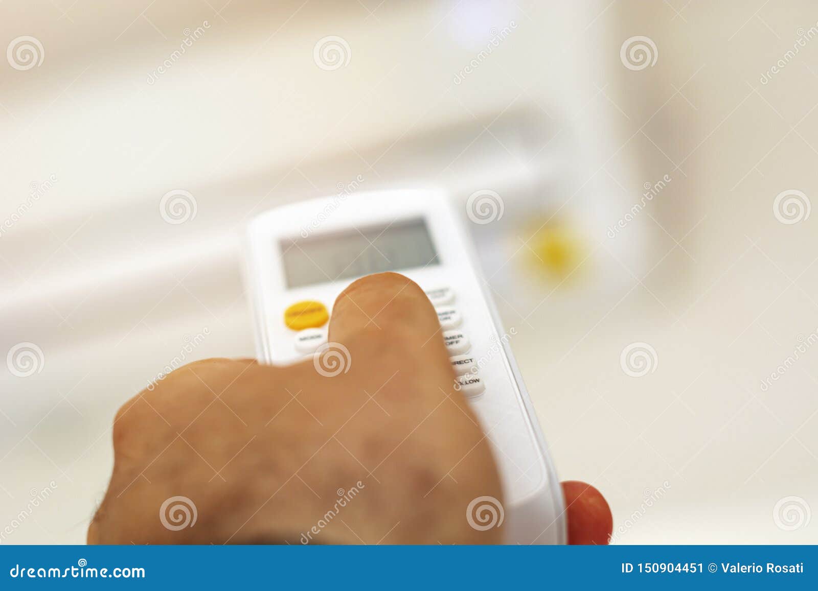 Close Up View Of A Hand Adjusting The Air Conditioning Temperature
