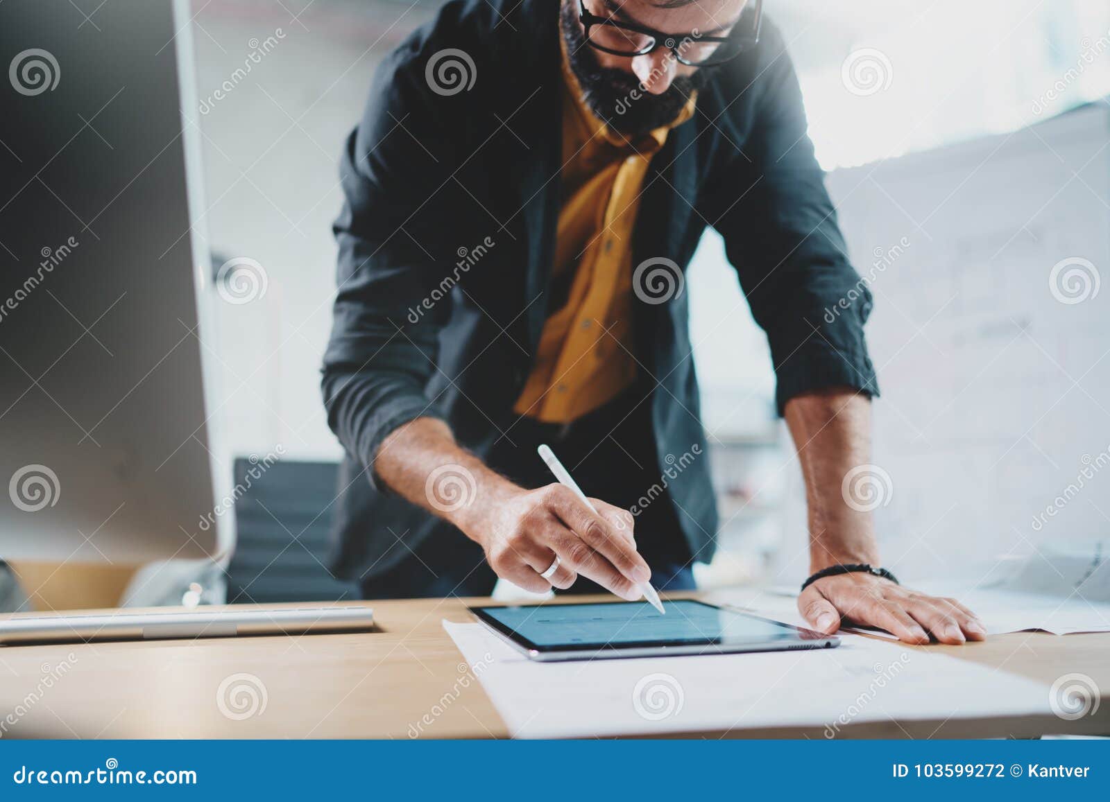 close up view of man in formal wear working with portable tablet computer and drawings digital plans in modern lightful