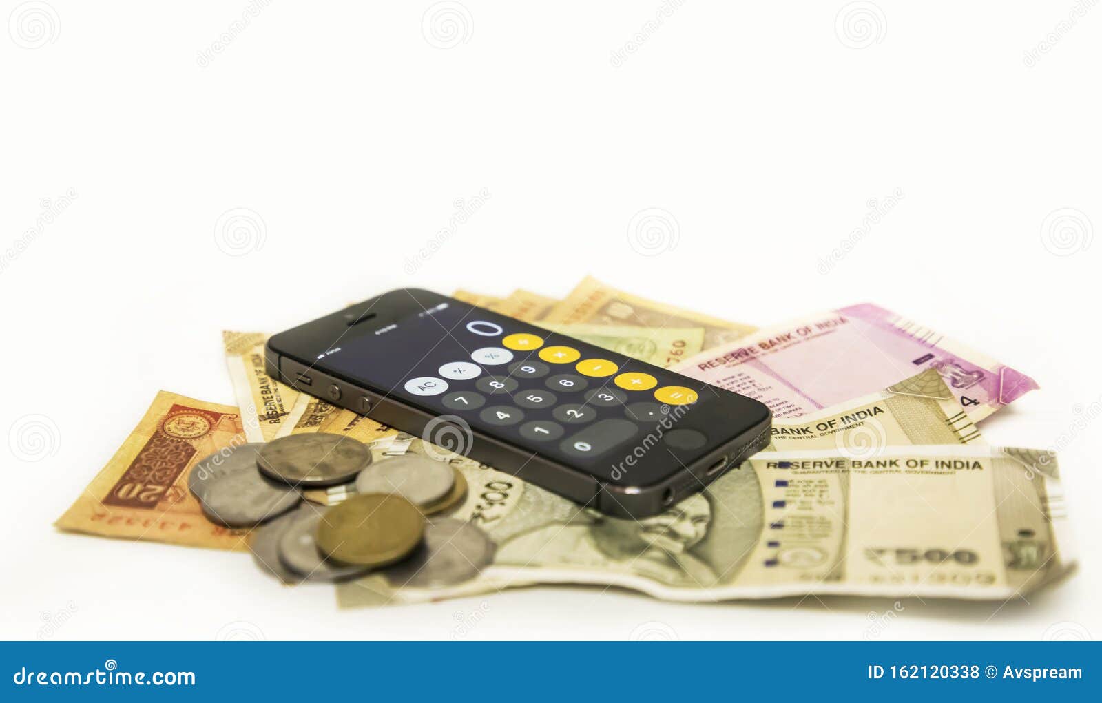close up view of mobile phone calculate and new indian rupees and coin