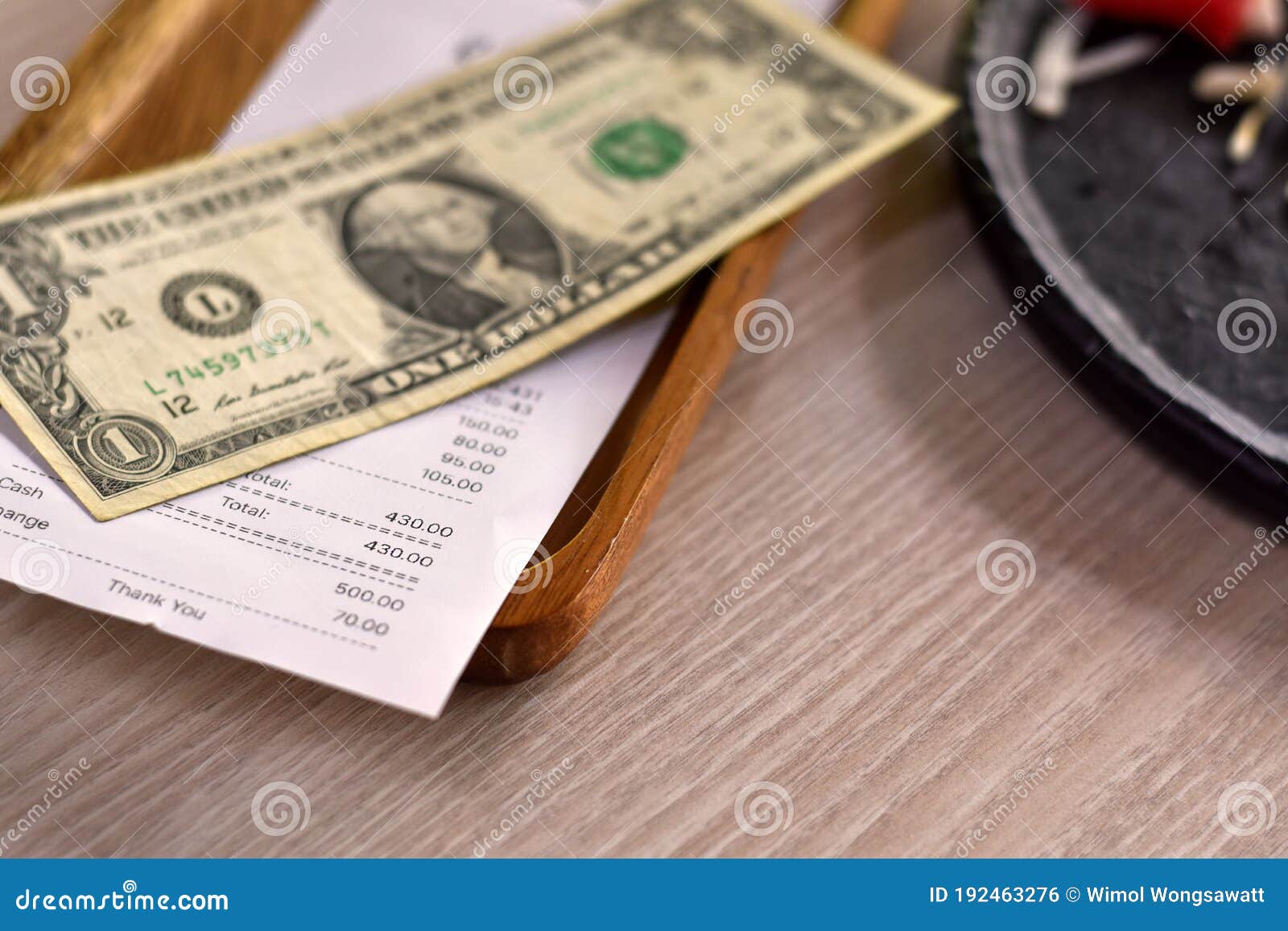 close-up view, money tip for service in the restaurant, money dollar on wooden plate.