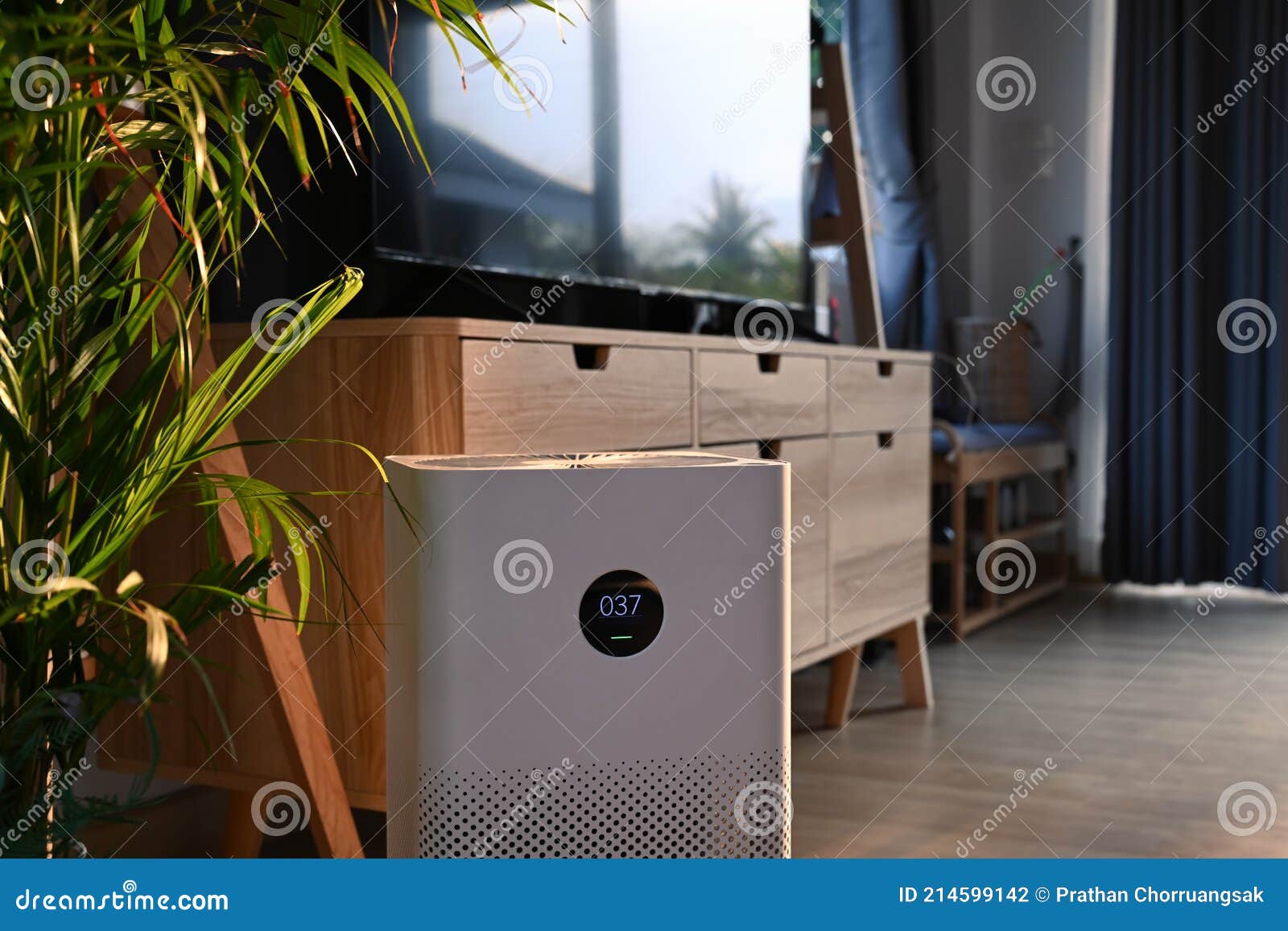 portable air purifier on wooden floor in comfortable home for improve air quality and healthy life.