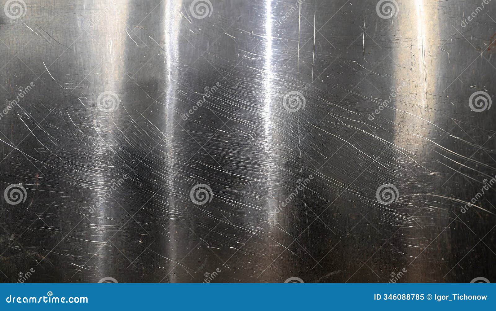 a close-up view of scratched metal surface with visible scuffs and a polished texture under light reflection