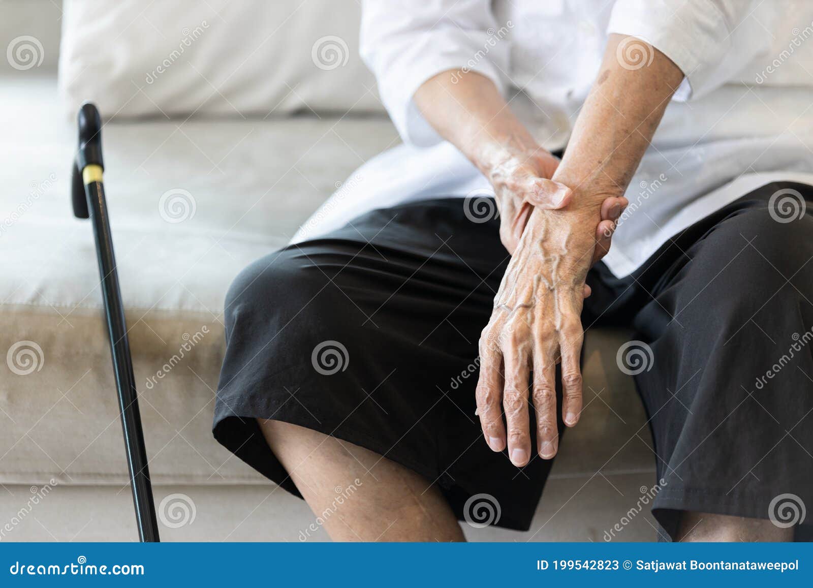 close up view on the shaking hand of the senior woman,symptom of resting tremor or parkinson`s disease,old elderly patient holdin