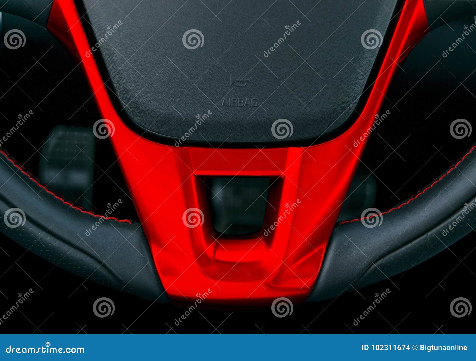 Close Up View Of Steering Wheel With Red Stich Black