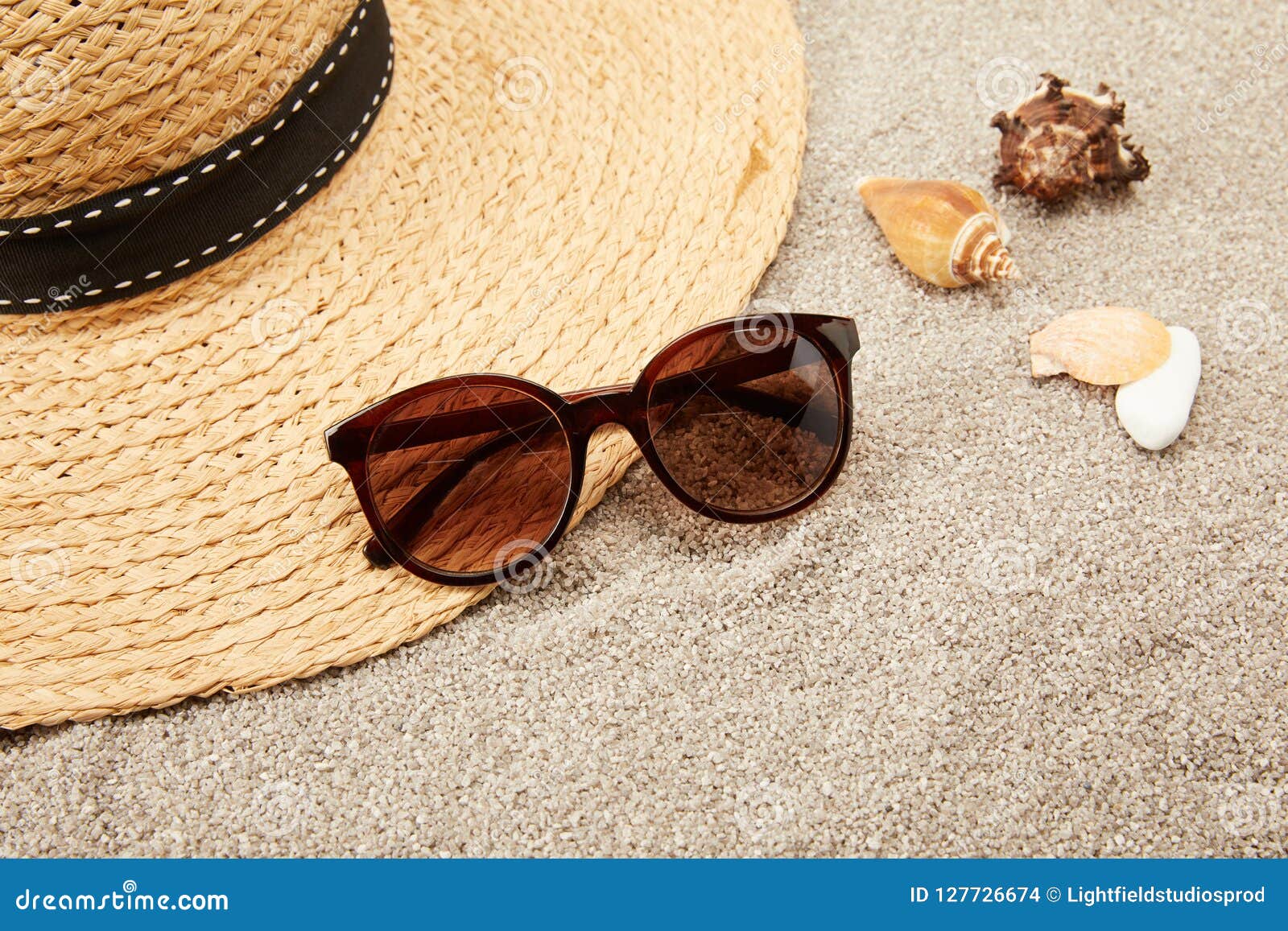 Close Up View of Straw Hat, Seashells and Sunglasses on Sand Stock ...