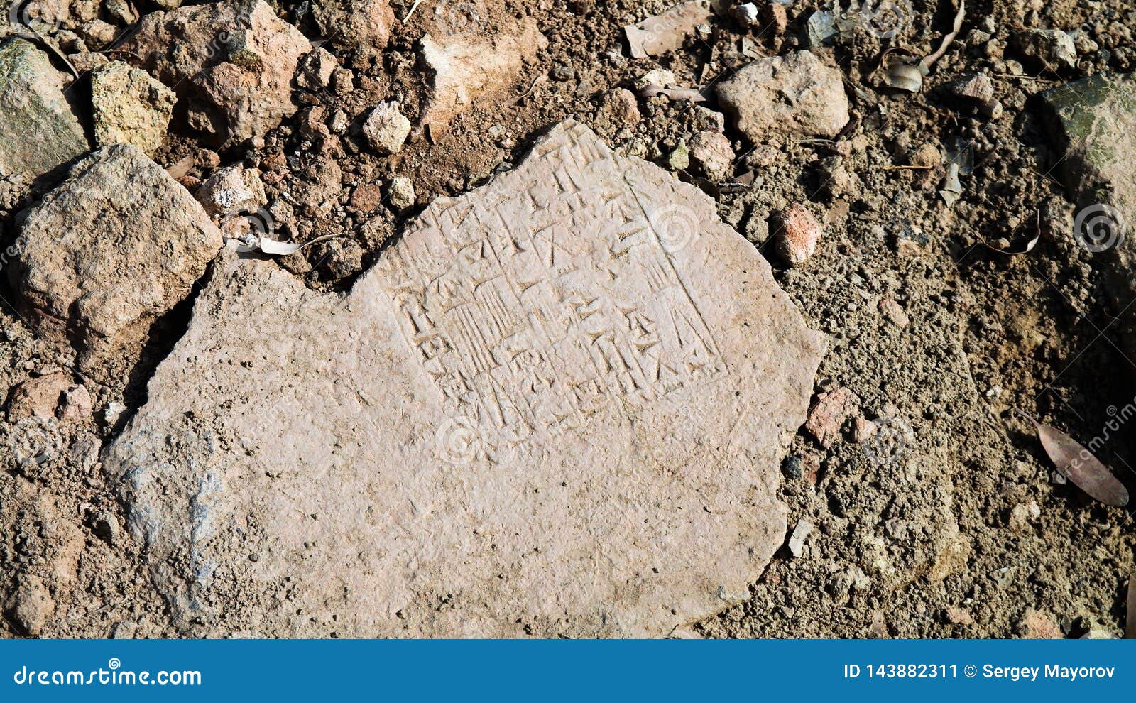 close-up view to plate with cuneiform sumerian text at the ruins of processional street of ancient babylon, hillah, iraq