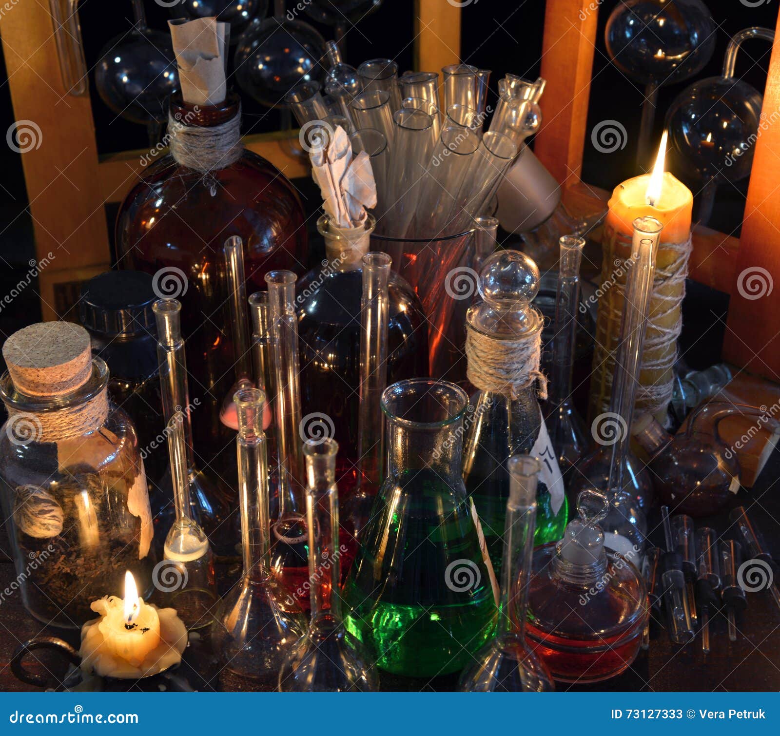 close up of vintage bottles, flask and candles in alchemy laboratory