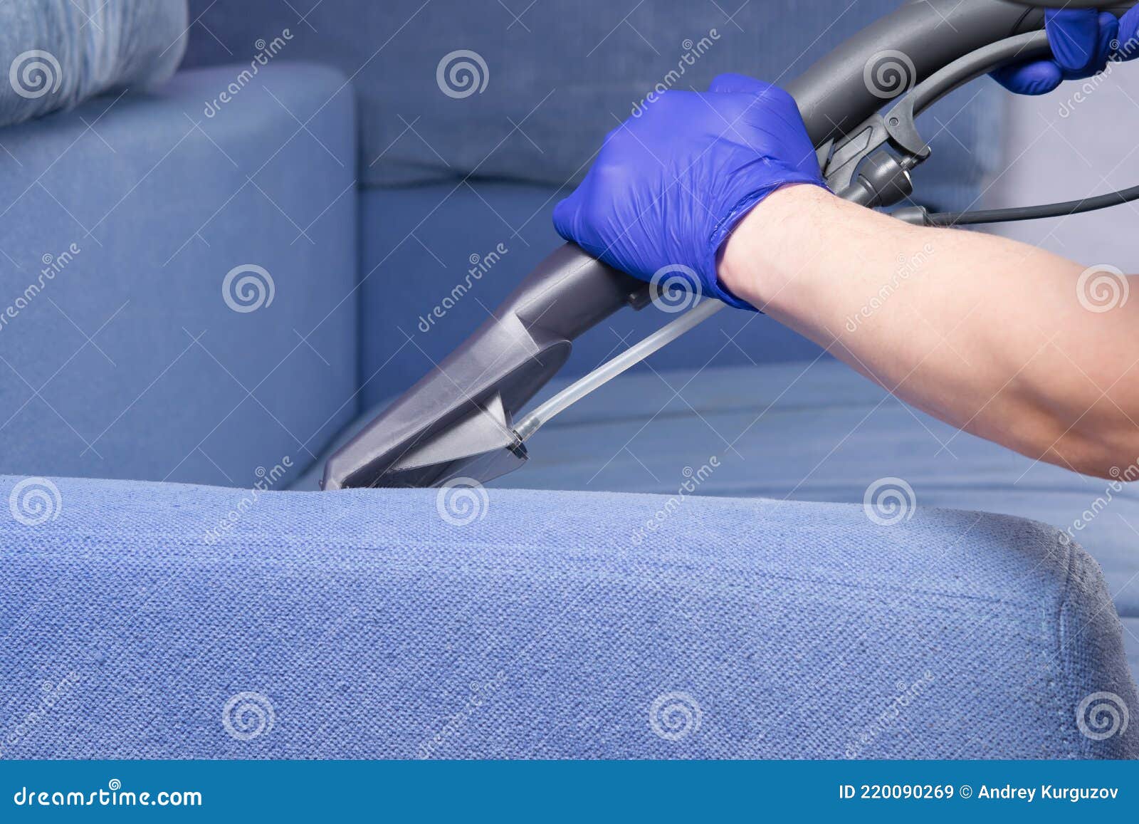 close-up of the washing vacuum cleaner, cleans the drapery of the sofa with water