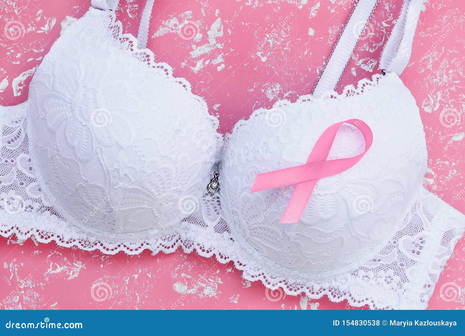 Close-up of White Lace Bra with Breast Cancer Awareness Ribbon on