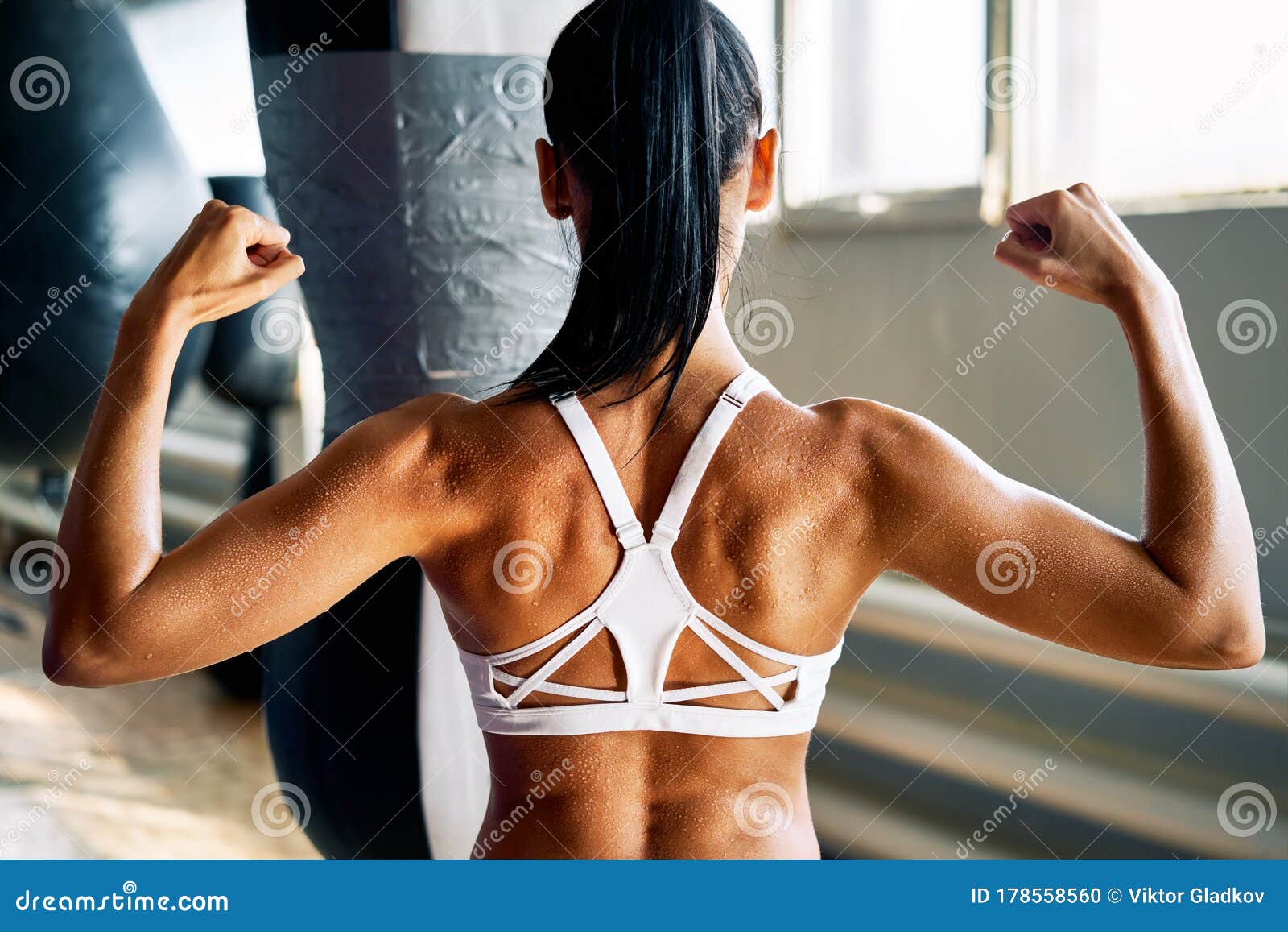 Strong muscular woman flexing his arms. Fit and healthy woman on white  background Stock Photo by ©bluebe 150201610