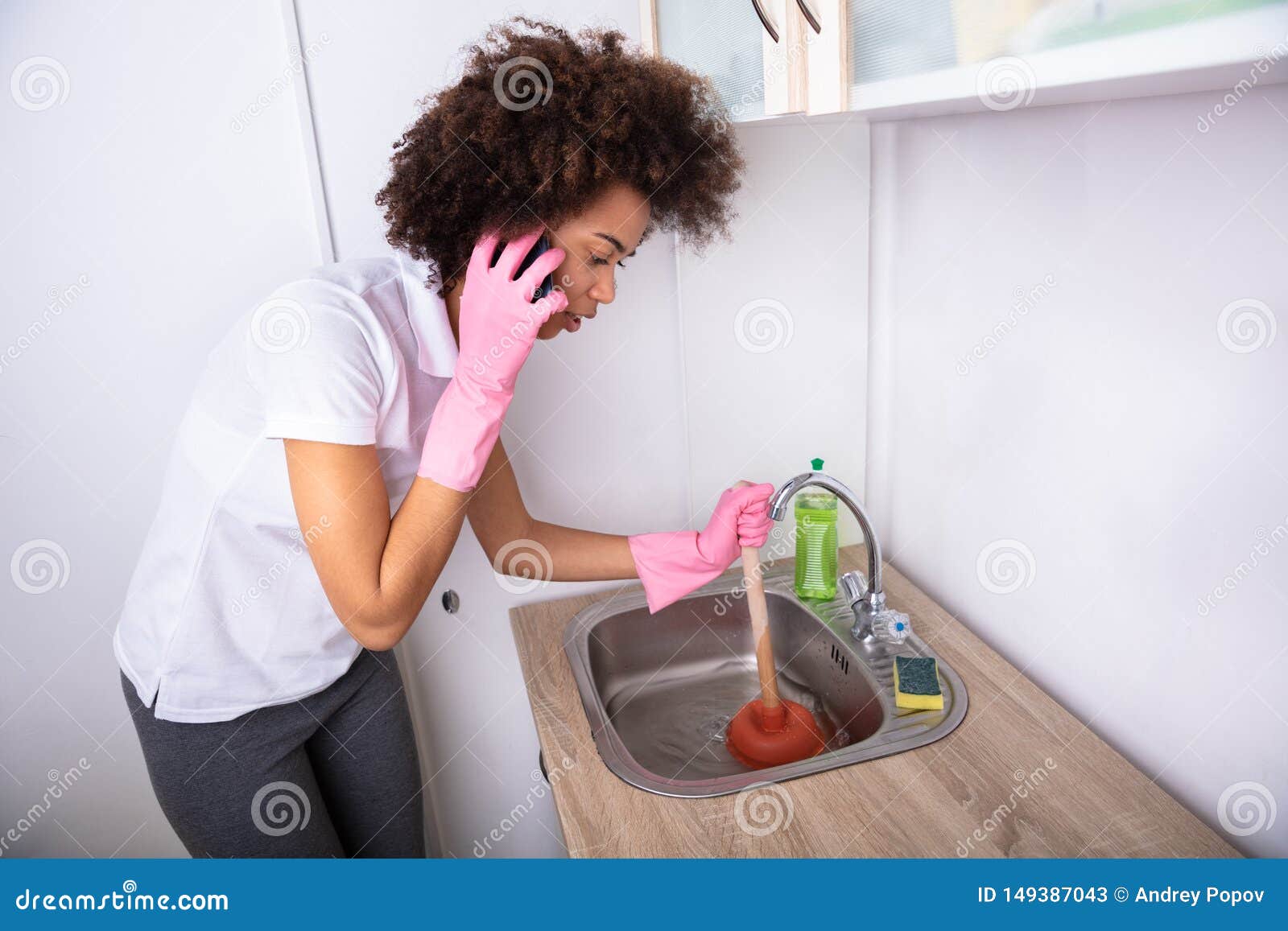 Young Handsome Man Using Plunger In Kitchen Sink Stock Photo, Picture and  Royalty Free Image. Image 23345778.