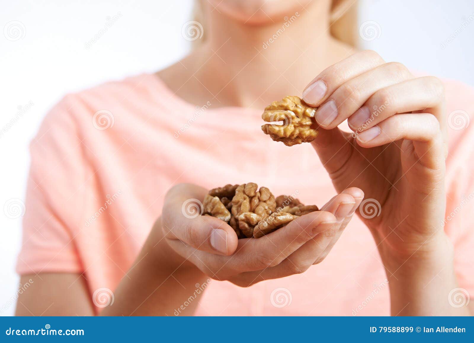 close up of woman eating walnuts