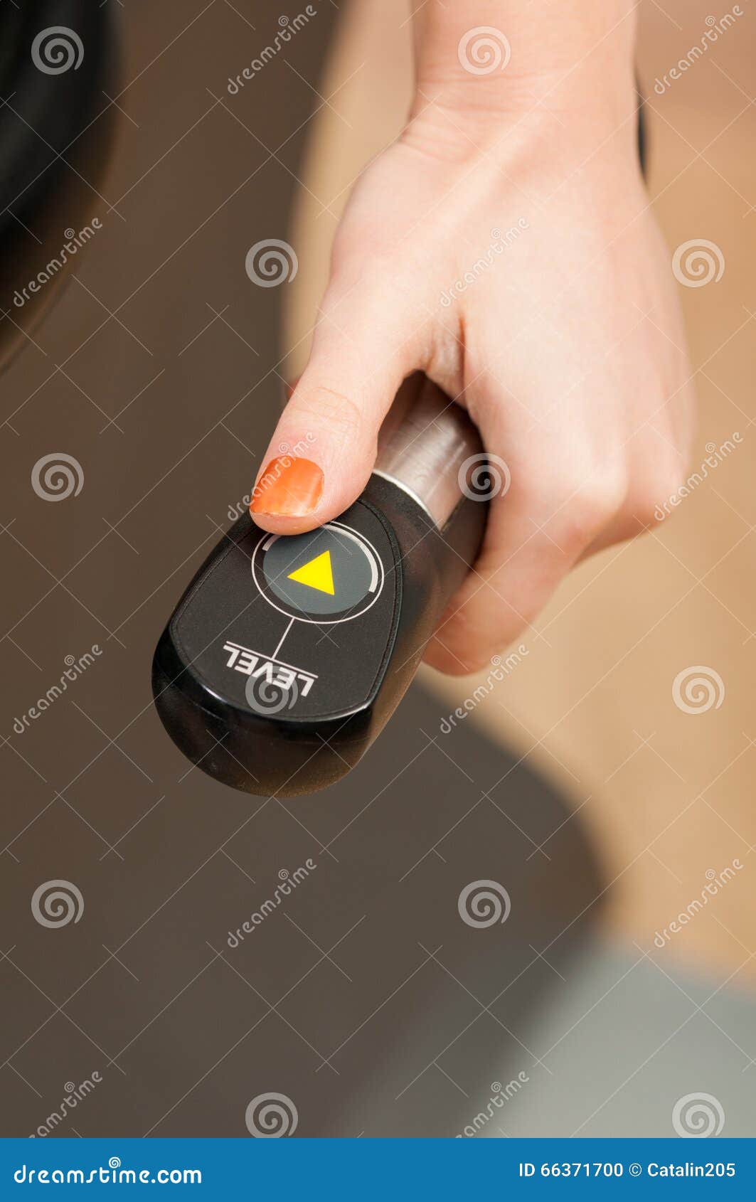 Closeup of Woman Hand Holding an Adjustable Handle Machine Stock Photo